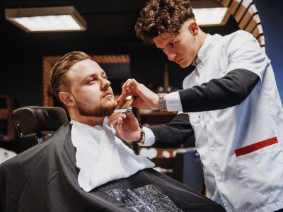 Men's hairstyling and haircutting in a barber shop or hair salon.